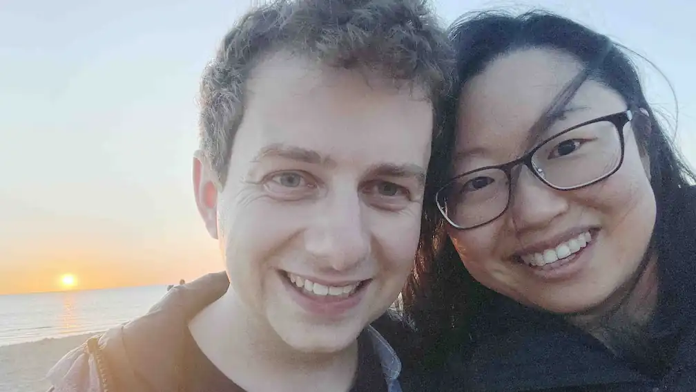 Mitch and Jojo smiling at sunset